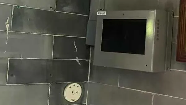 RFID patrol point checkpoint tag mounted on a tiled corridor wall